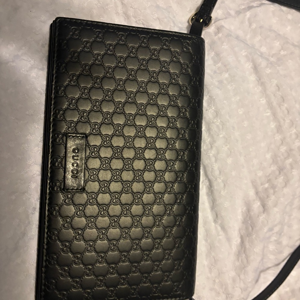 Authentic Gucci Embossed Black wallet on a chain.